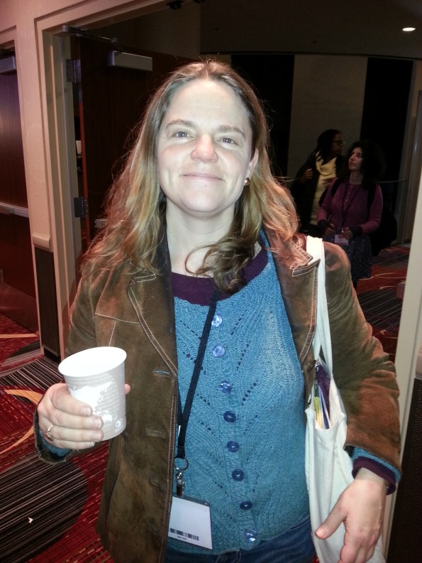 Yes, she has her knitting project in that white bag, just in case there's a 2-minute lull